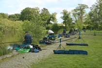 A lakeside view of anglers at Bron Eifion